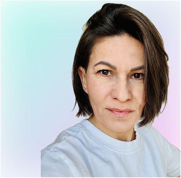 Portrait of a man with brown hair and glasses on a flat gray background.