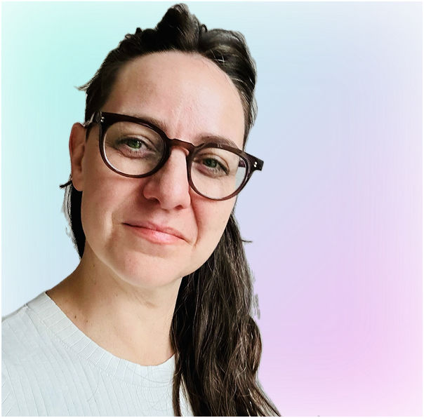 Portrait of a woman with brown hair on a flat gray background.